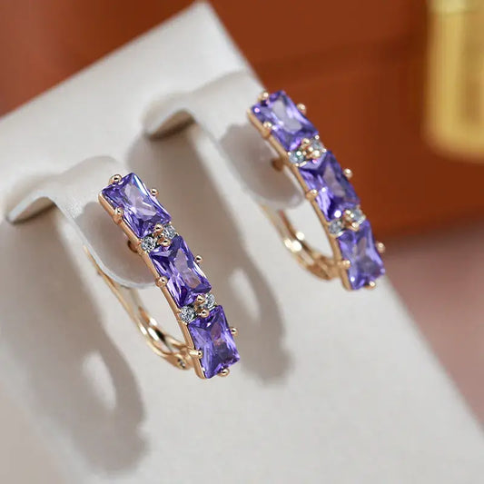 Elegant gold earrings with purple crystals