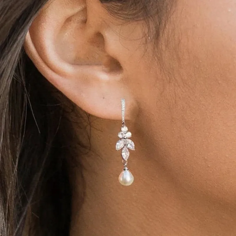 Earrings with dangling pearls in zirconia leaves